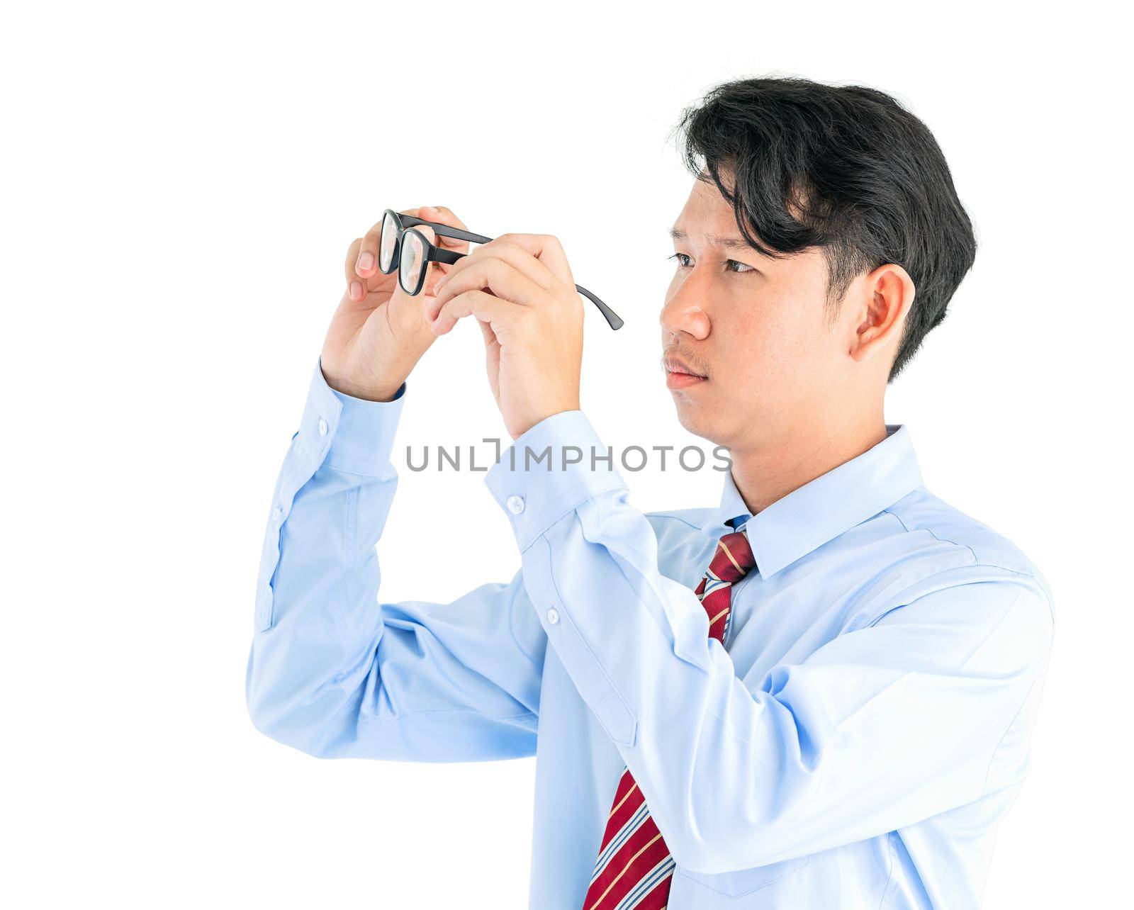 Male wearing blue shirt and red tie holding eyeglasses isolated on white background