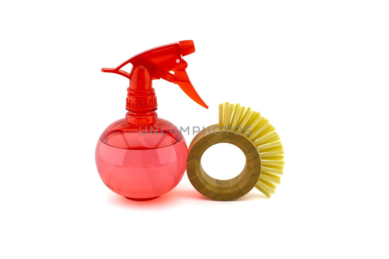 Spray bottle and bamboo dish brushes isolated on a white background. House cleaning products