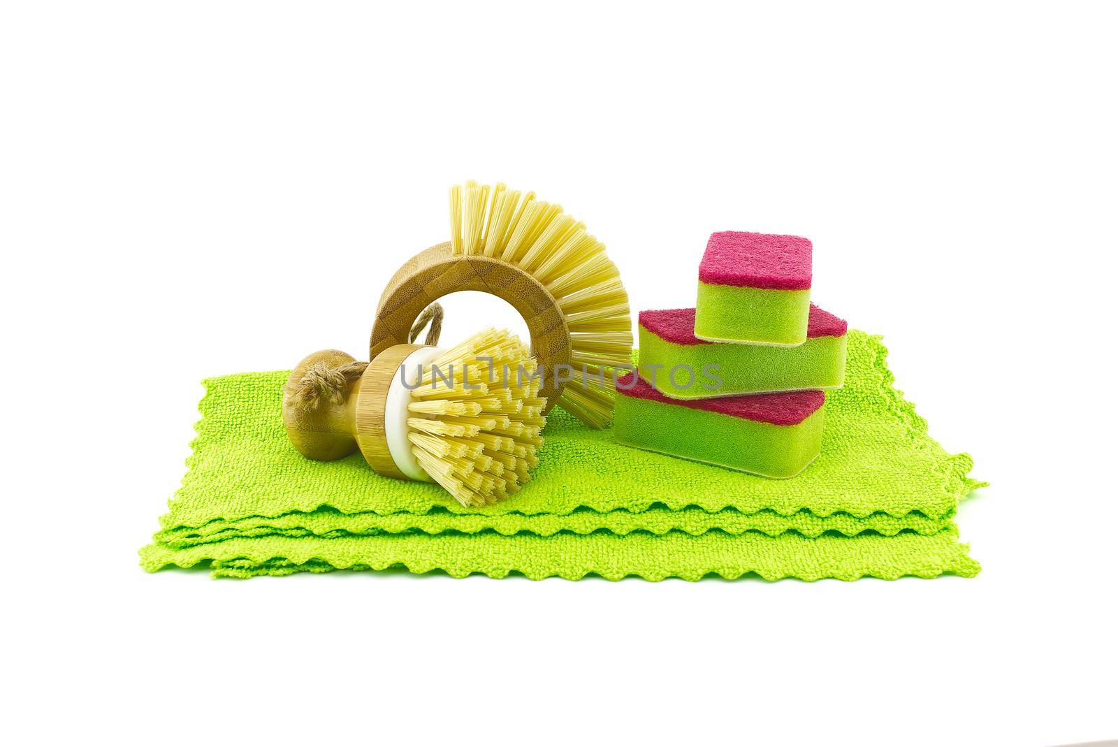 Multicolored cleaning sponges and dish brushes on microfiber cloth isolated on a white background. House cleaning products