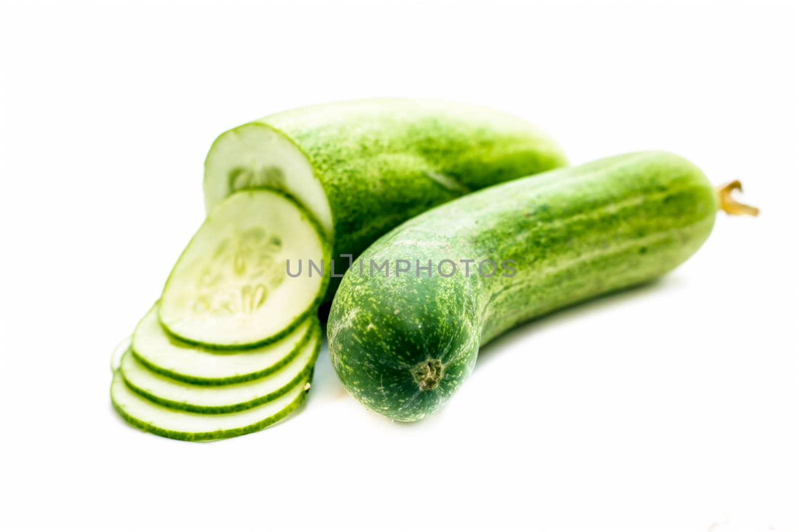 Raw cut sliced cucumber isolated on white.