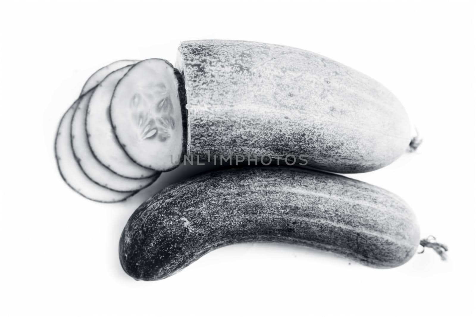 Raw cut sliced cucumber isolated on white.