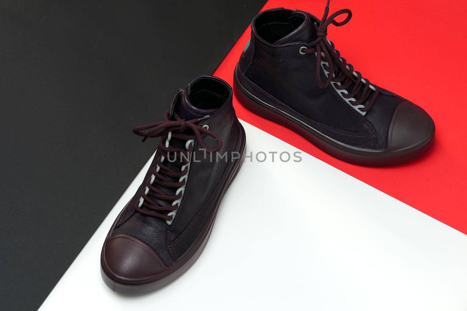 A pair of trendy stylish shoes or sneakers on a colored background with a space for text. High quality photo