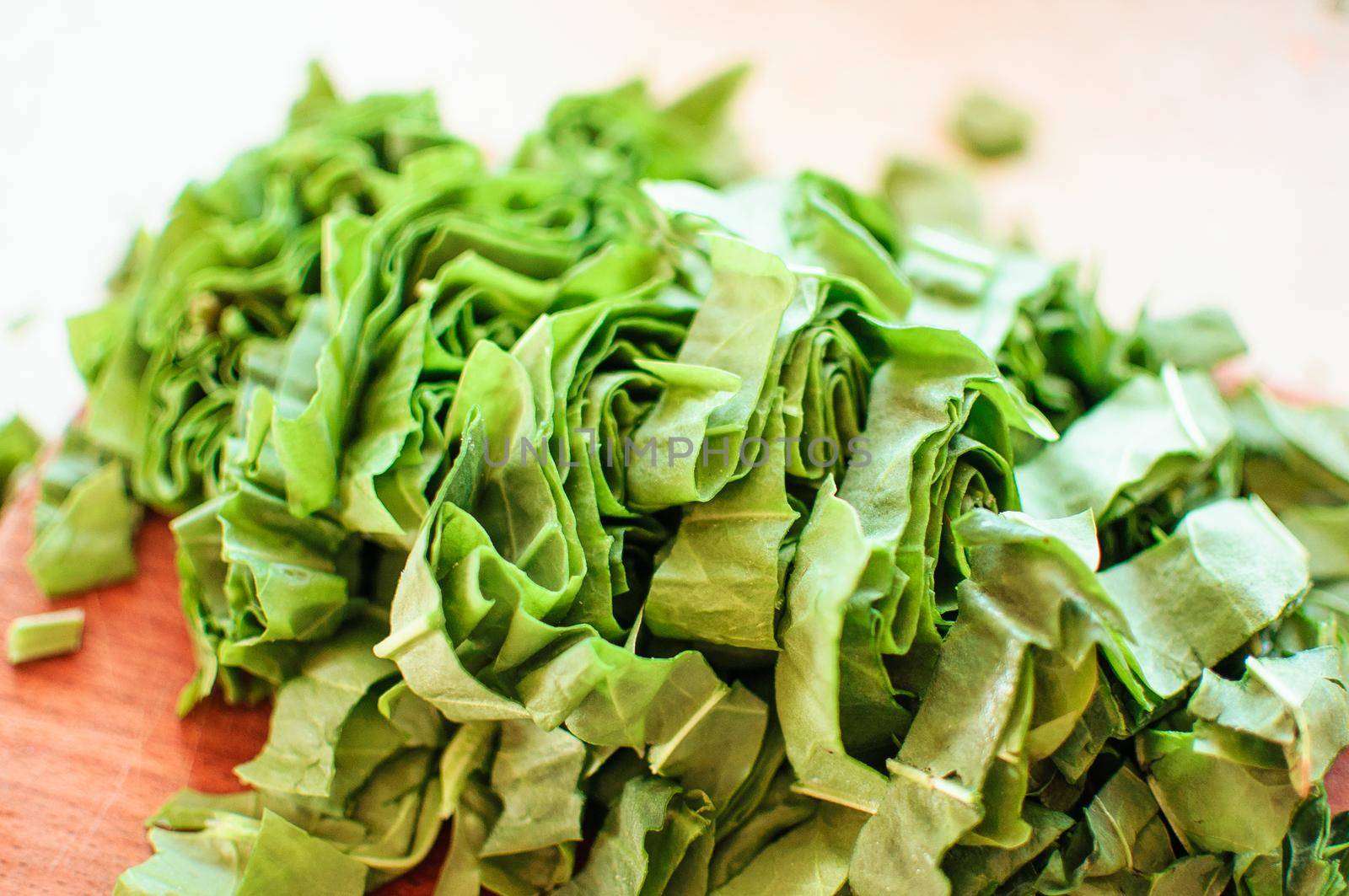 Fresh organic sorrel,plant spinach heap on wooden table for spring green vegetables soup and salad.Raw sorrel leaves top view green vegetable background.Spring green vegetables,sorrel spinach