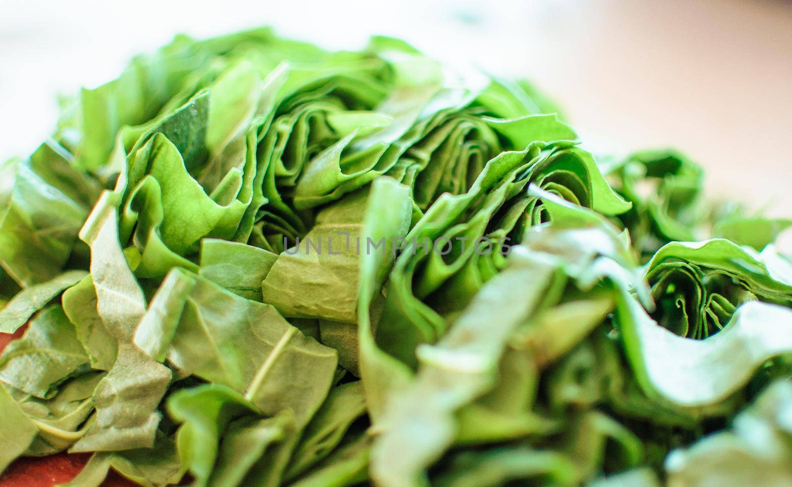 Fresh organic sorrel,plant spinach heap on wooden table for spring green vegetables soup and salad.Raw sorrel leaves top view green vegetable background.Spring green vegetables,sorrel spinach