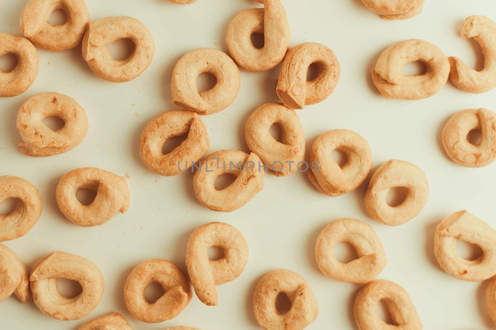 Taralli - a traditional Italian snack similar to drying or bagels, typical for the cuisine of Sicily and Calabria. Bagel on a white background, isolate pattern. Copy space.