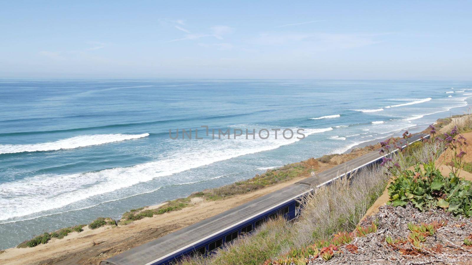 Del Mar, California USA - 23 Jan 2020: Pacific surfliner train, travel ocean beach. Passenger railroad, public transit. Express rapid intercity double decker blue commuter. Amtrak railway transport.