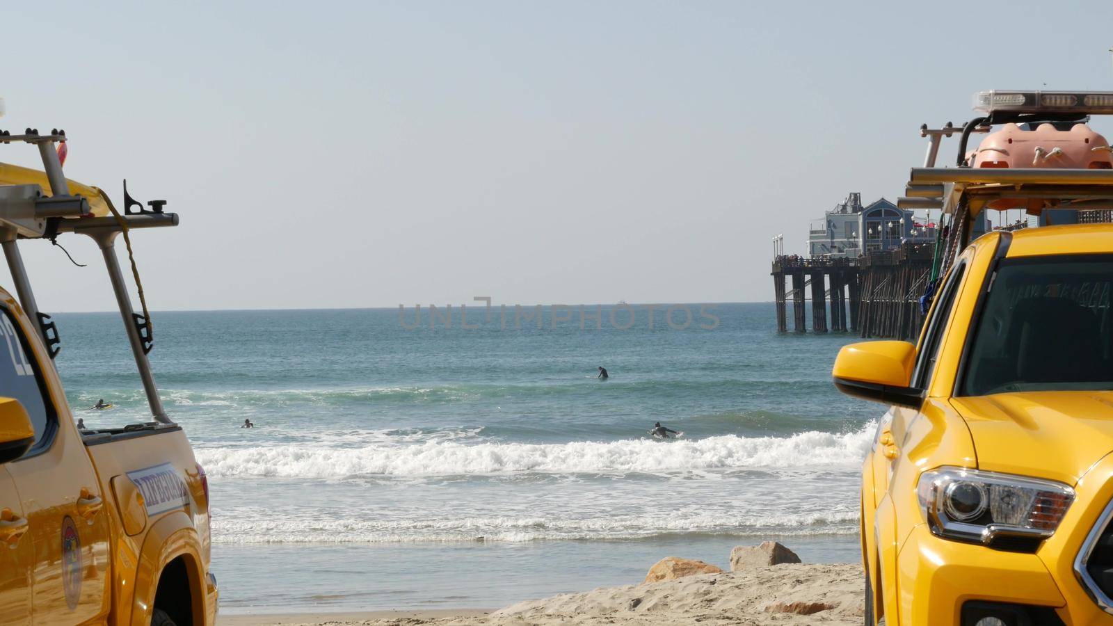 Oceanside, California USA - 8 Feb 2020: Yellow lifeguard car, beach near Los Angeles. Coastline rescue, life guard Toyota pick up truck, lifesavers vehicle. Iconic auto on ocean coast. Public safety.