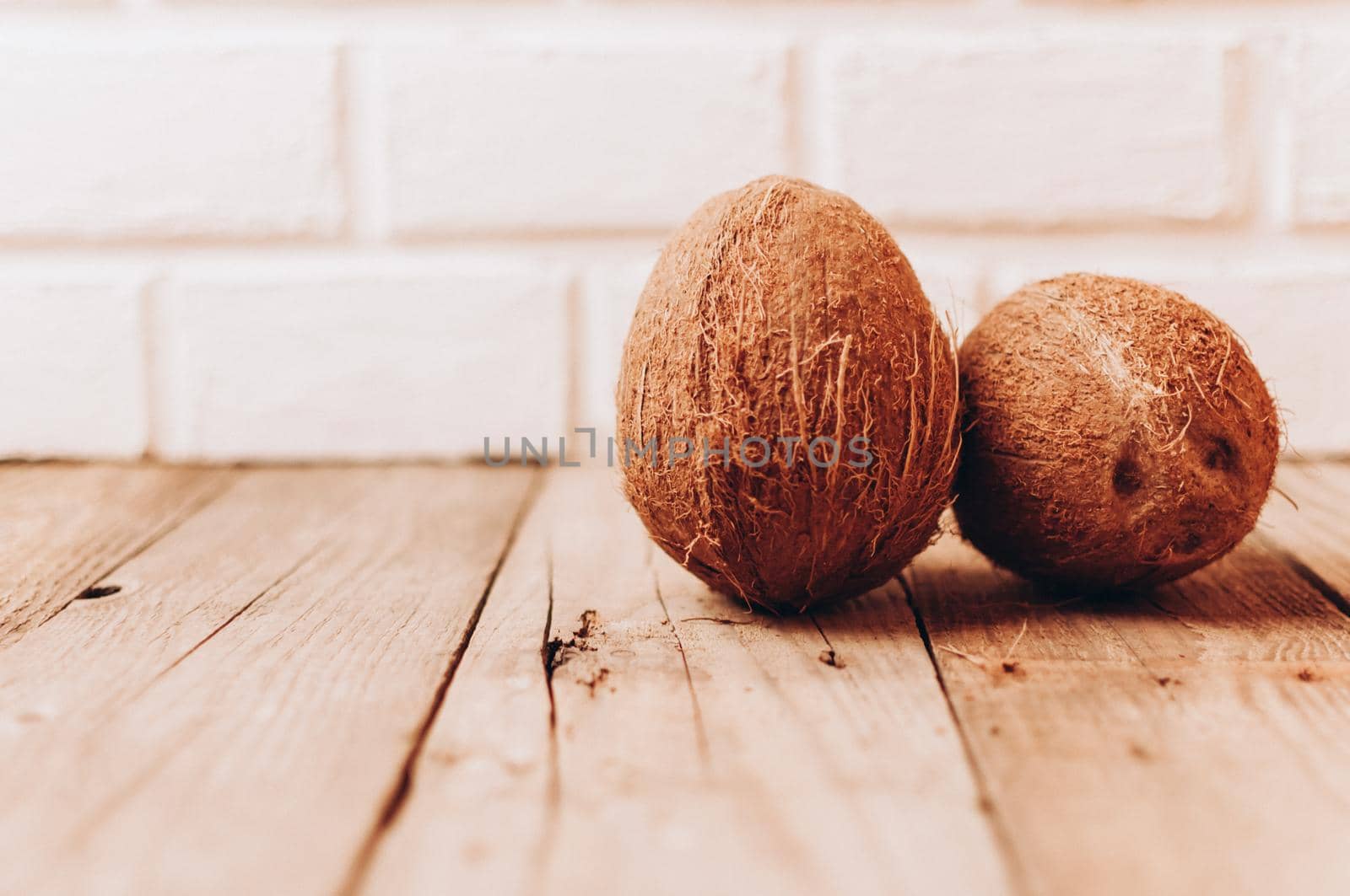 tropical coconut fruits on a wooden background in rustic style. Template for design. Copy space.