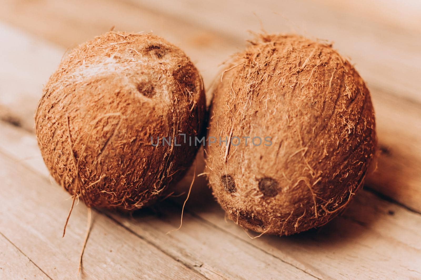 tropical coconut fruits on a wooden background in rustic style. Template for design. Copy space.