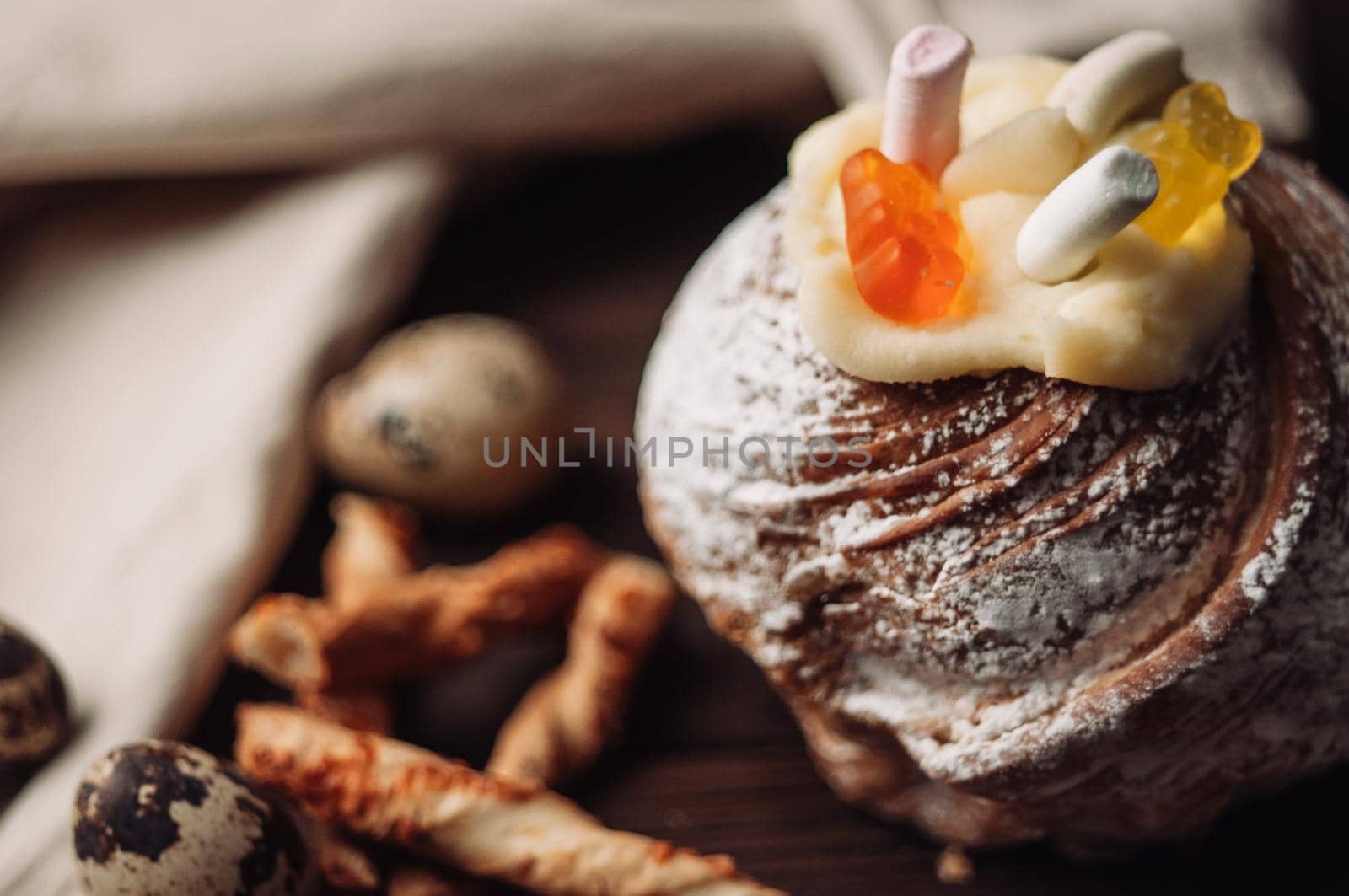 Stylish Easter cake with marshmallows and jelly bears on a dark rustic wooden background. Seasonal Happy Easter greetings. selective focus. modern happy easter image