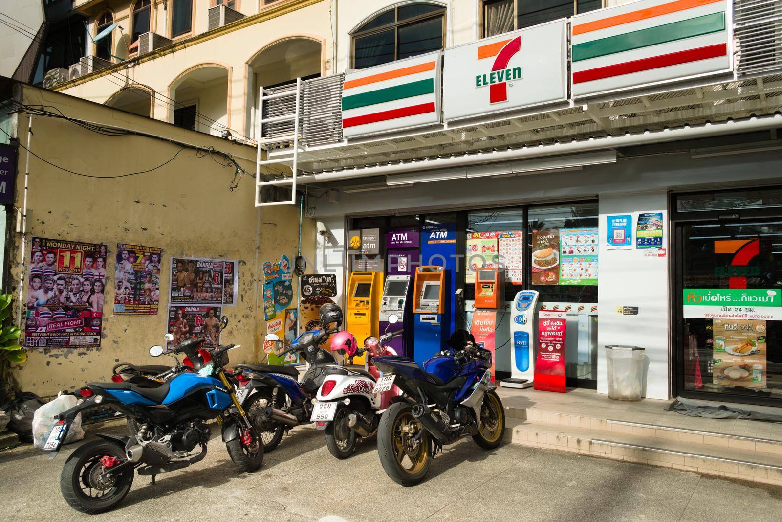 2019-11-05 / Phuket, Thailand - Parked motorcyles outside of a 7-Eleven store. by hernan_hyper