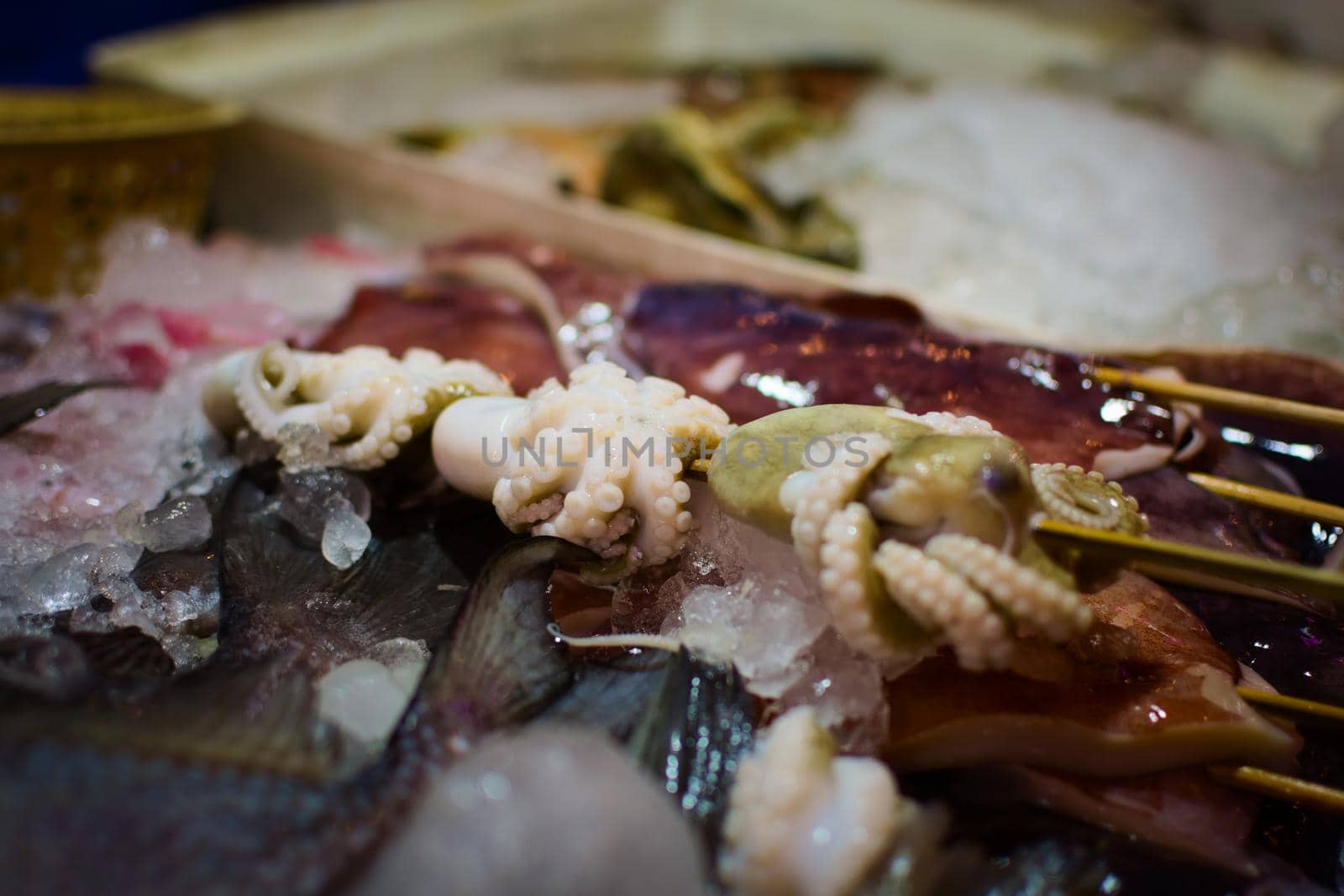 Raw octopus skewer in a market stall in Phuket, Thailand.