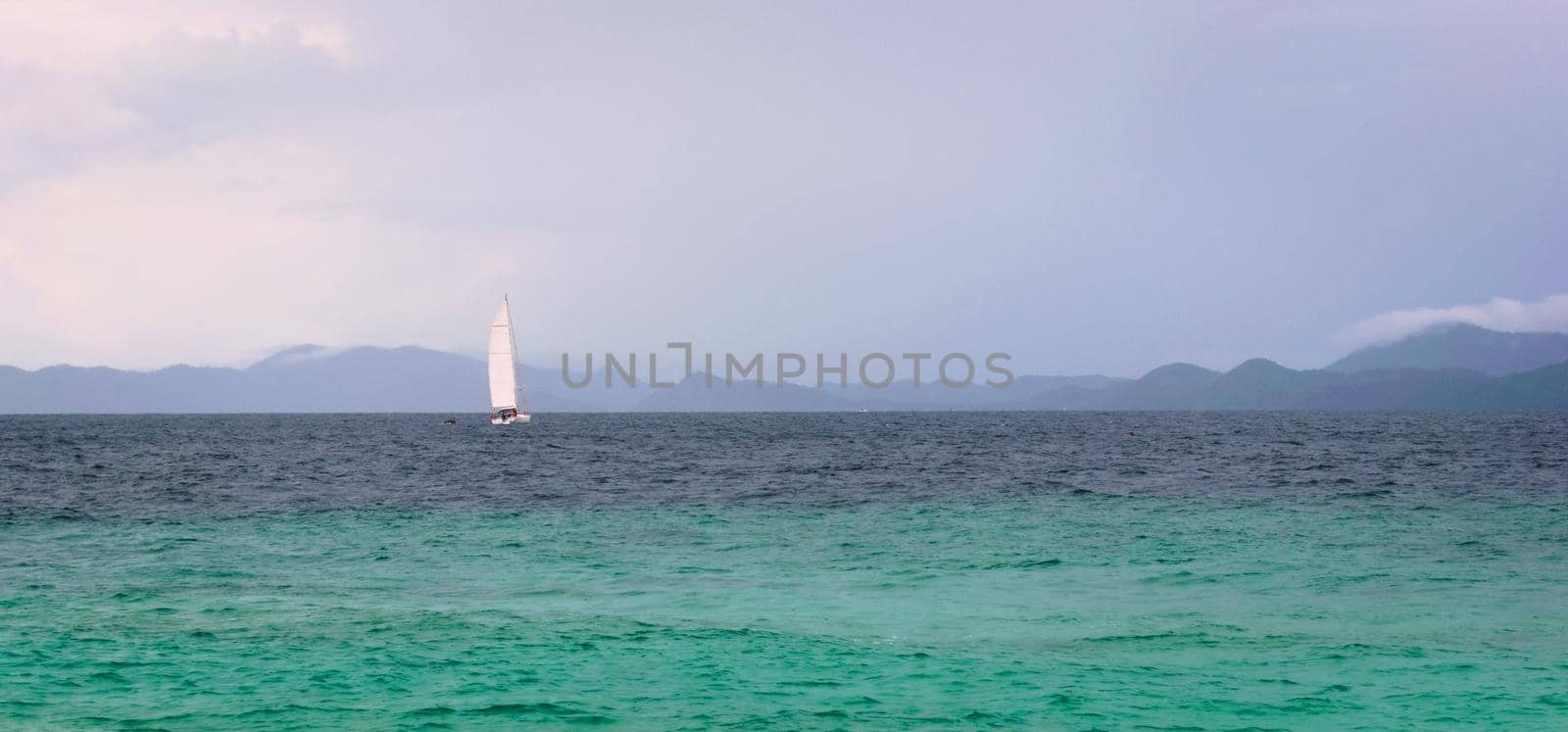Sailboat on the turquoise waters of Andaman Sea, near Phuket, Thailand. by hernan_hyper
