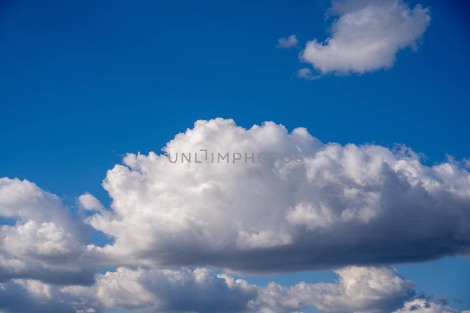 Beautiful blue sky with fluffy white clouds. Wonderful summer or spring day with clear sky and white clouds.
