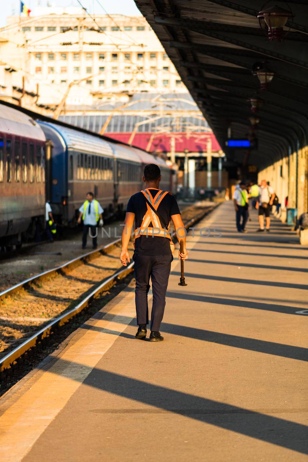 Train crew man doing checkings on the platform at the Bucharest North Railway Station in Bucharest, Romania, 2020 by vladispas
