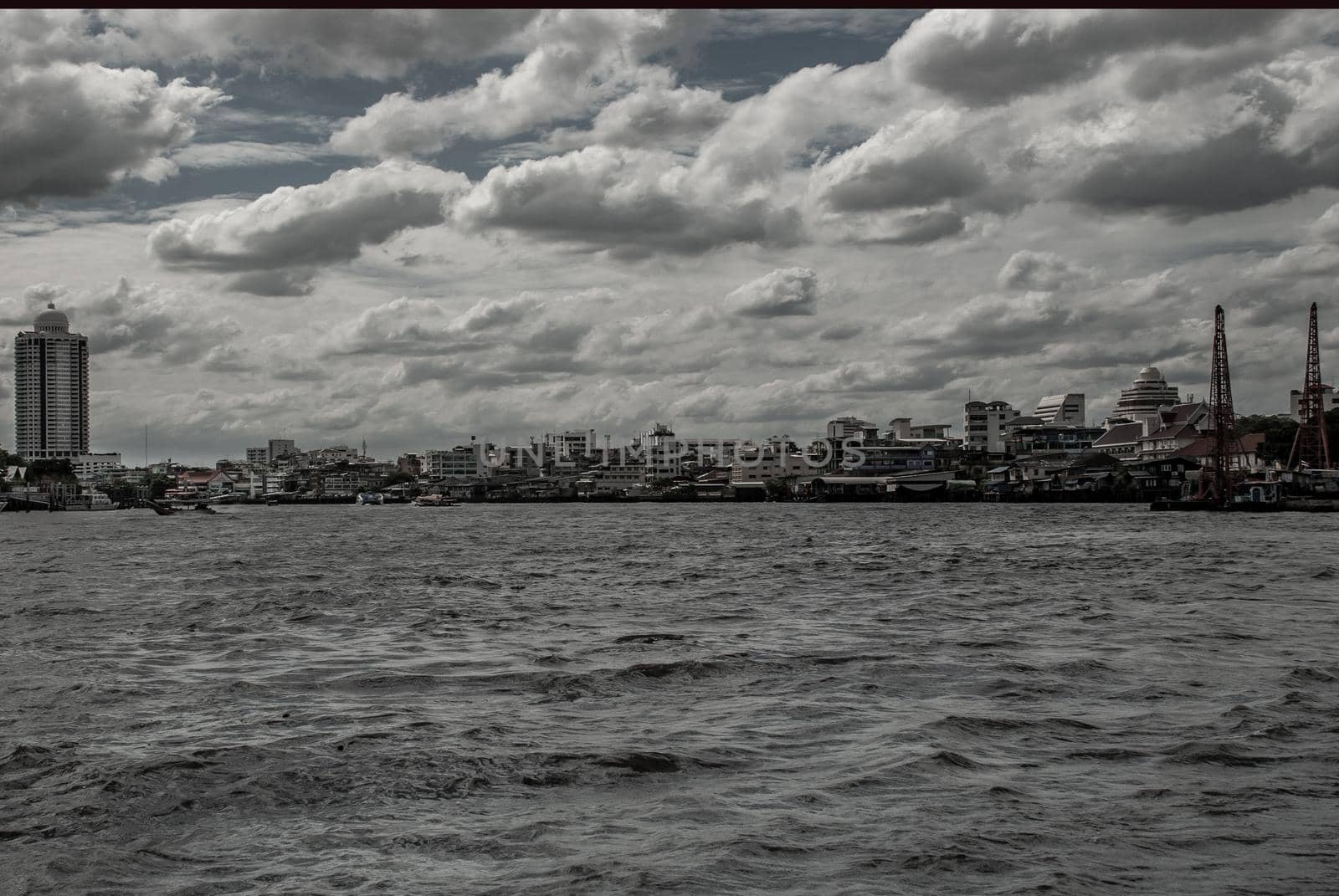 Bangkok, Thailand - 21 Jul 2019 : A view of the bank of Bangkok's Chao Phraya River showing the several tall buildings in the beautiful skyline.
