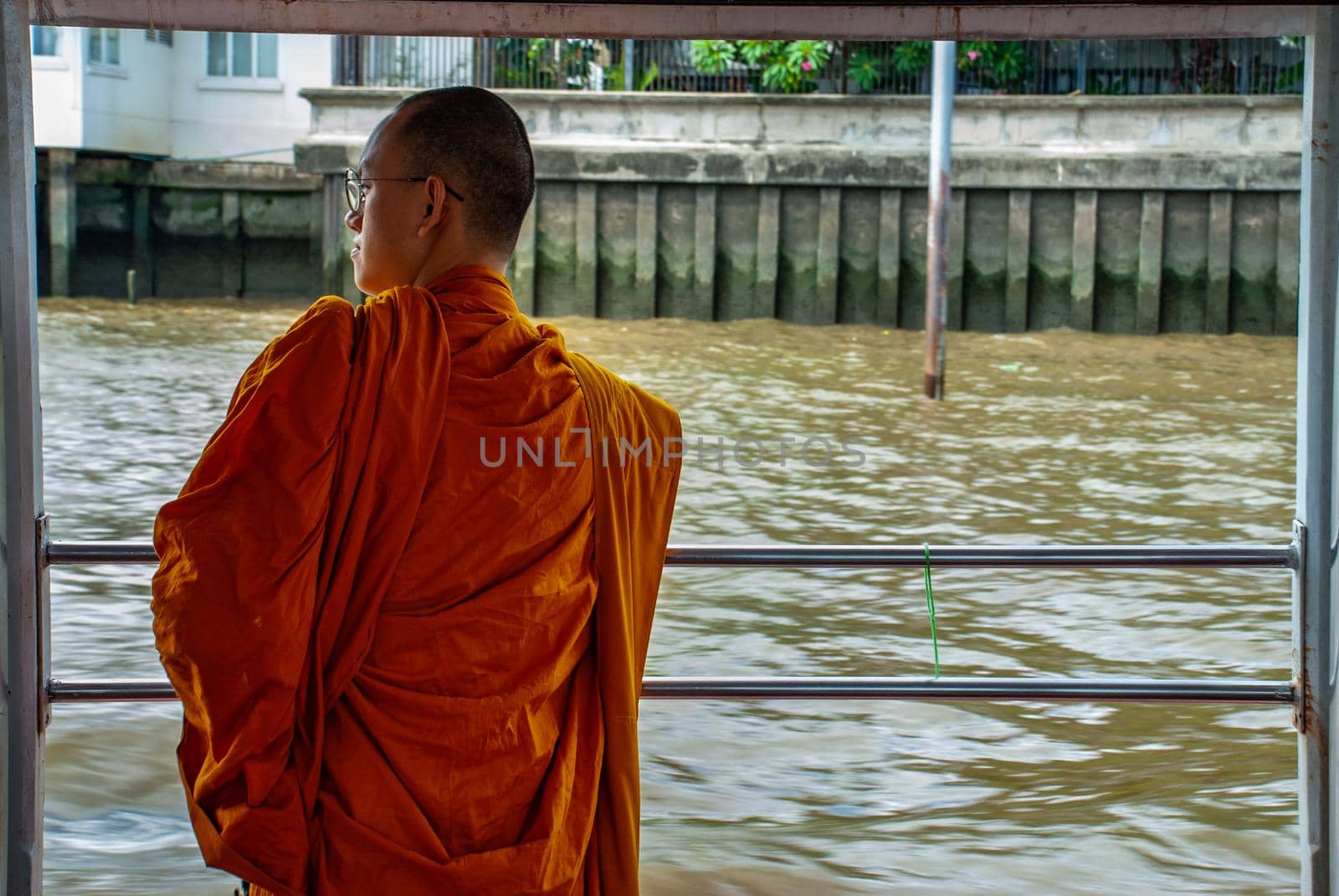 Bangkok, thailand 21 Jul, 2019 : The monks stood on the Chao Phraya Express Boat to travel by water to the temple.