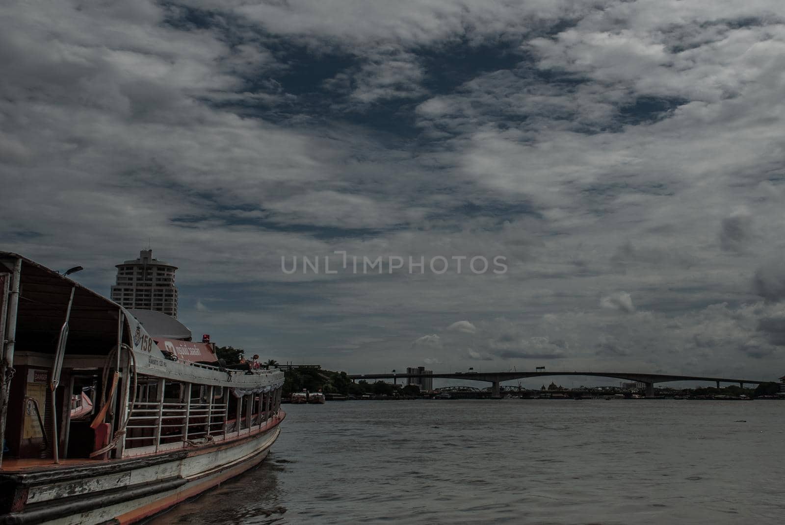 Bangkok, Thailand, 21 Jul 2019: View of the Chao phraya Express Boat and Krung Thep Bridge in the background.
