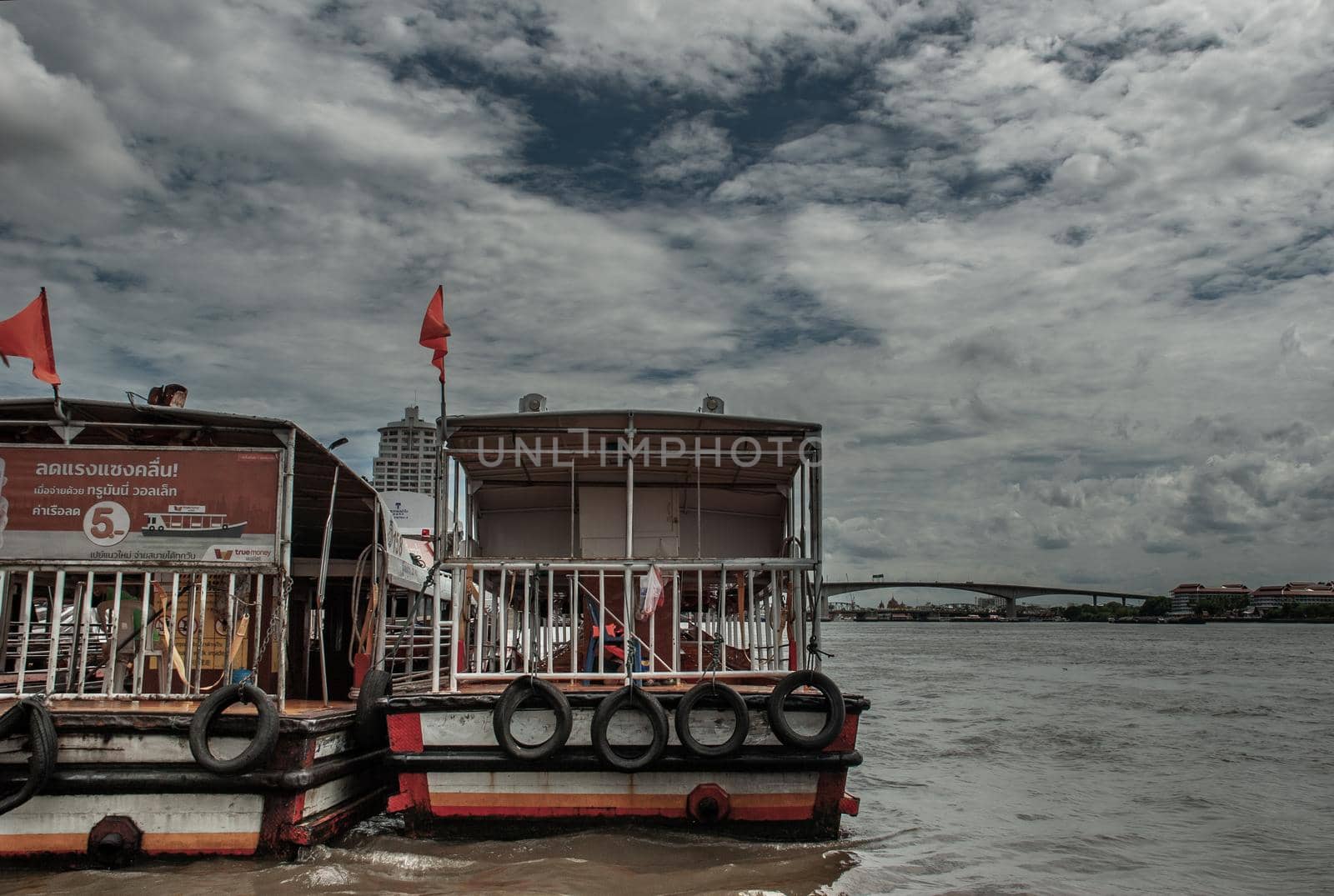 Bangkok, Thailand, 21 Jul 2019: View of the Chao phraya Express Boat and Krung Thep Bridge in the background.