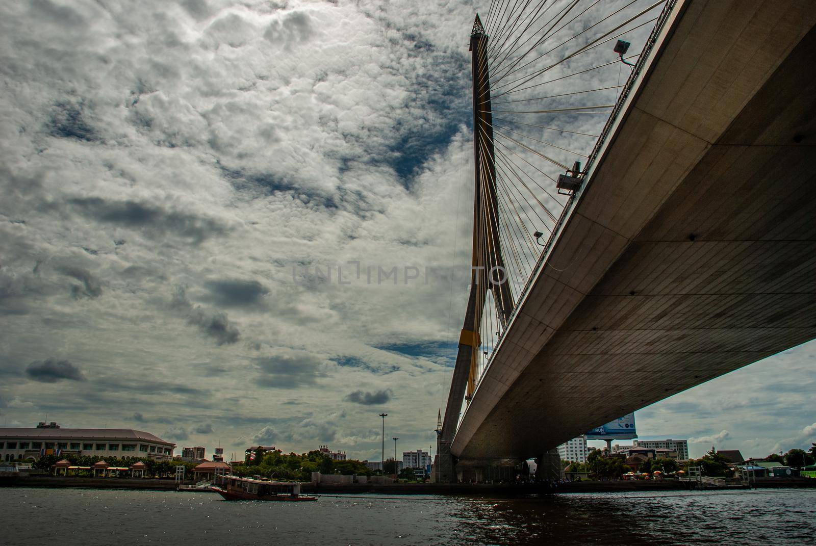 Bangkok, thailand 21 Jul, 2019 : Rama VIII bridge, Rope Bridge across the Chao Phraya River, A tall V-shape pylon tower with view blue sky is background, Cloudy day.