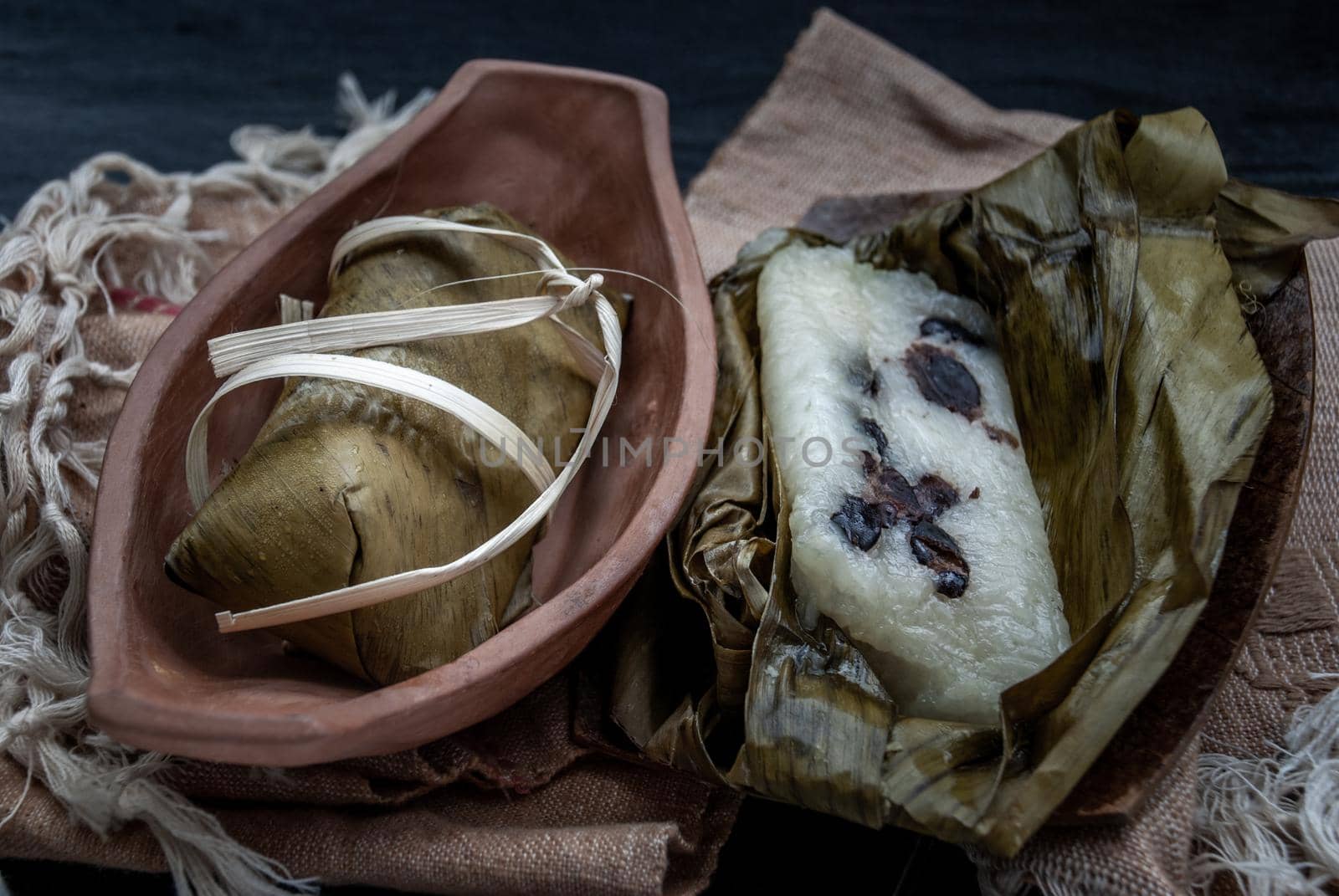 Khao tom mat, a Laotian and Thai dessert of seasoned steamed sticky rice wrapped in banana leaves normally inserted with filling made of banana and black beans for special occasions or merit making, Steamed mung bean with sticky rice.