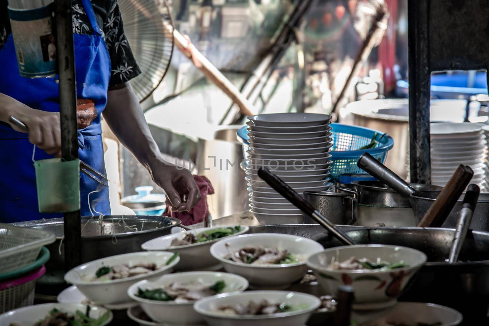 Bangkok, Thailand - 27 Oct 2019 : Chef cooking egg Noodles with roasted pork in local restaurant, Thailand street food. making noodle in Traditional Asian Food. Chinese egg noodle and hot boiled soup, Selective focus.