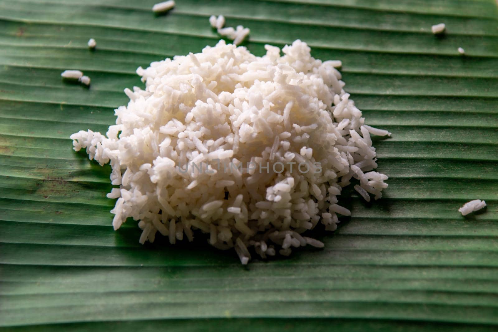White rice is cooked rice by steaming or boiling on served on a banana leaf in Thai restaurant that is staple food in Thailand, Selective focus.