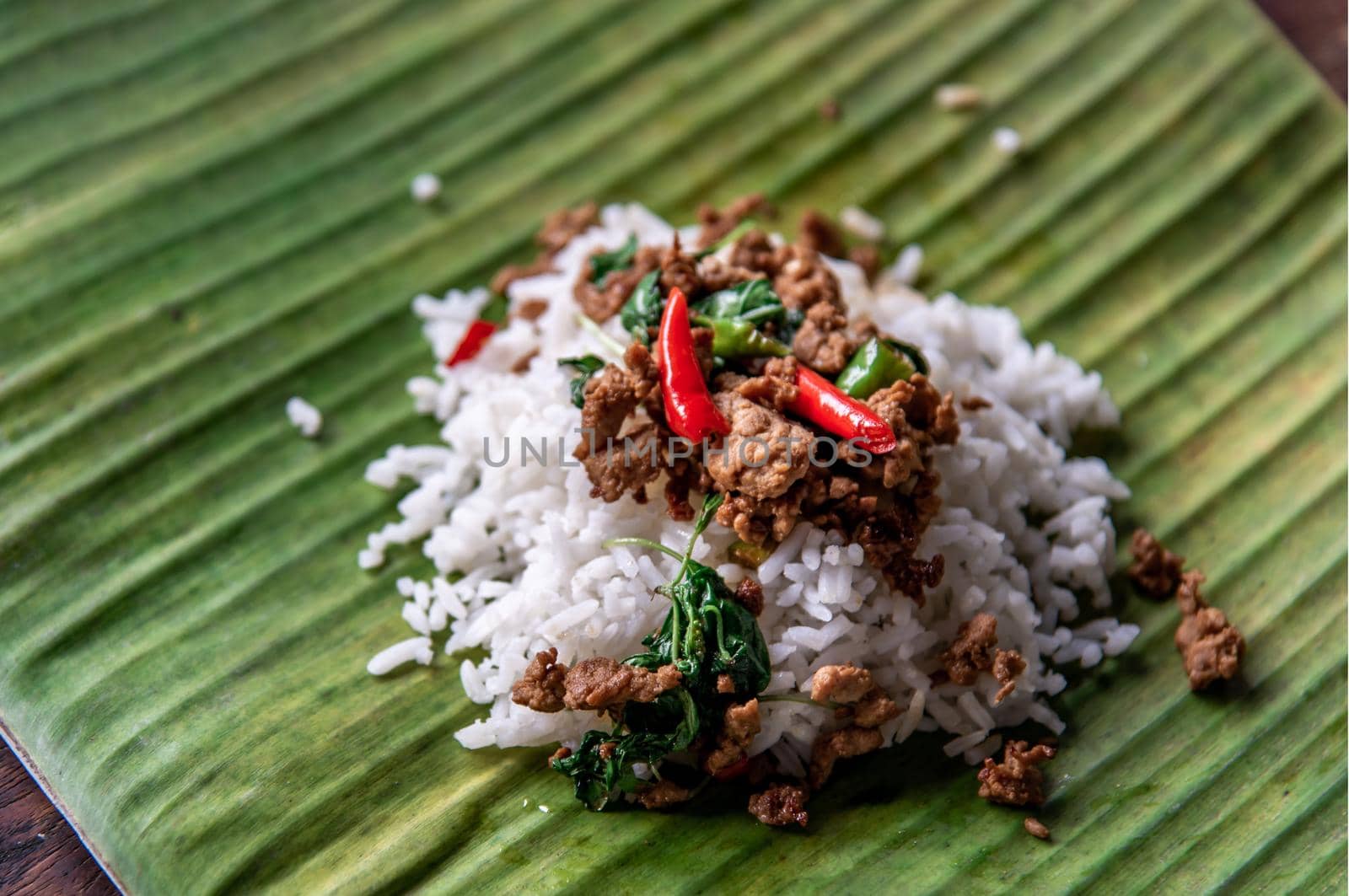 Rice topped with Stir fried Thai basil with minced pork (Pad Ka Prao Moo) on served on a banana leaf, A world renowned delicacy from Thailand, Selective focus.
