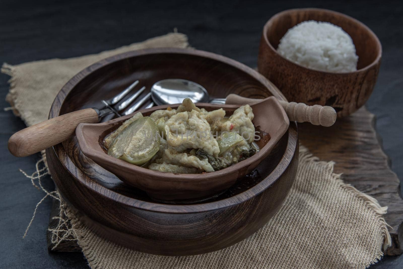 Kaeng kheow hwan is green curry with fish ball served with steamed rice. Popular traditional food of Thailand. look delicious. Oblique view from the top, Selective focus.