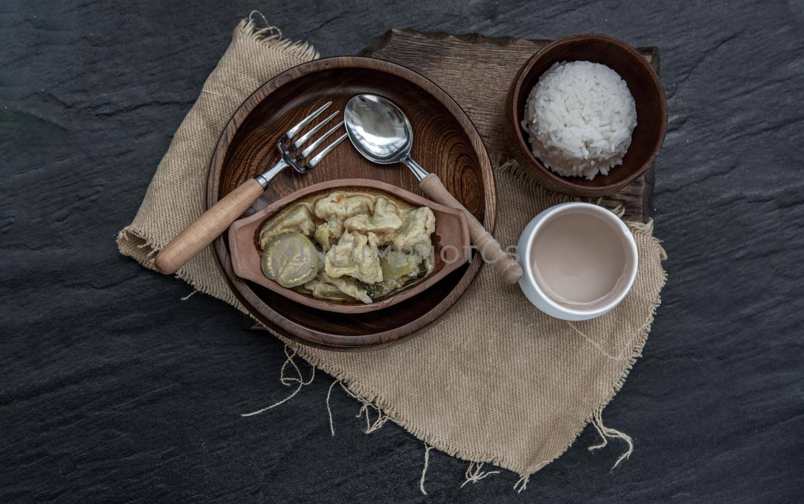 Kaeng kheow hwan is green curry with fish ball served with steamed rice. Popular traditional food of Thailand. look delicious. Top view, Selective focus.