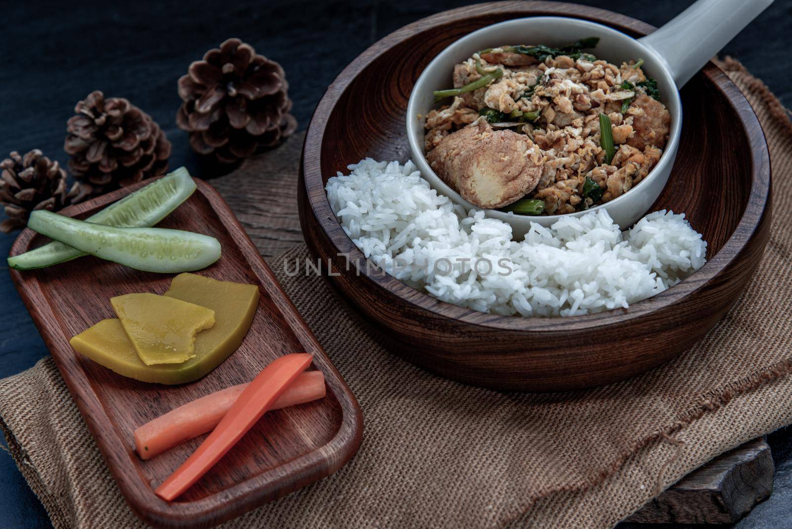 Thai food, Stir fried egg tofu with spring onion with Herbs vegetables served with steamed rice in wooden bowl, Oblique view from the top.