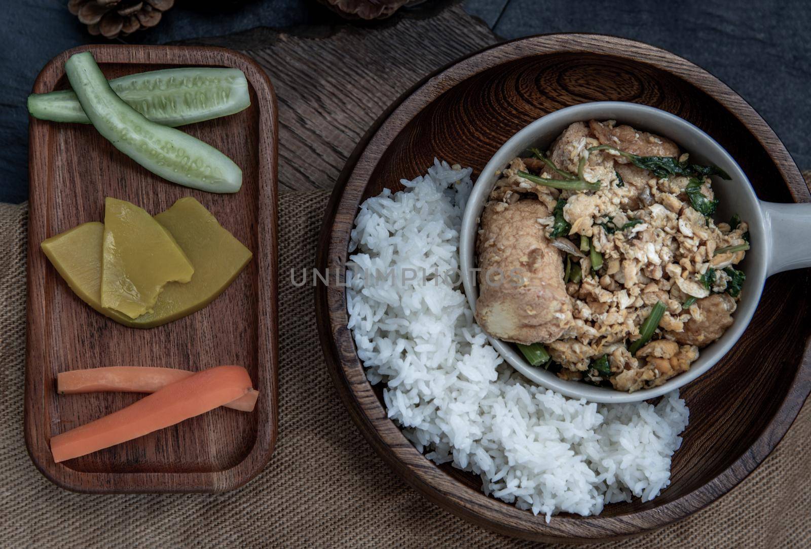 Thai food, Stir fried egg tofu with spring onion with Herbs vegetables served with steamed rice in wooden bowl, view from above.
