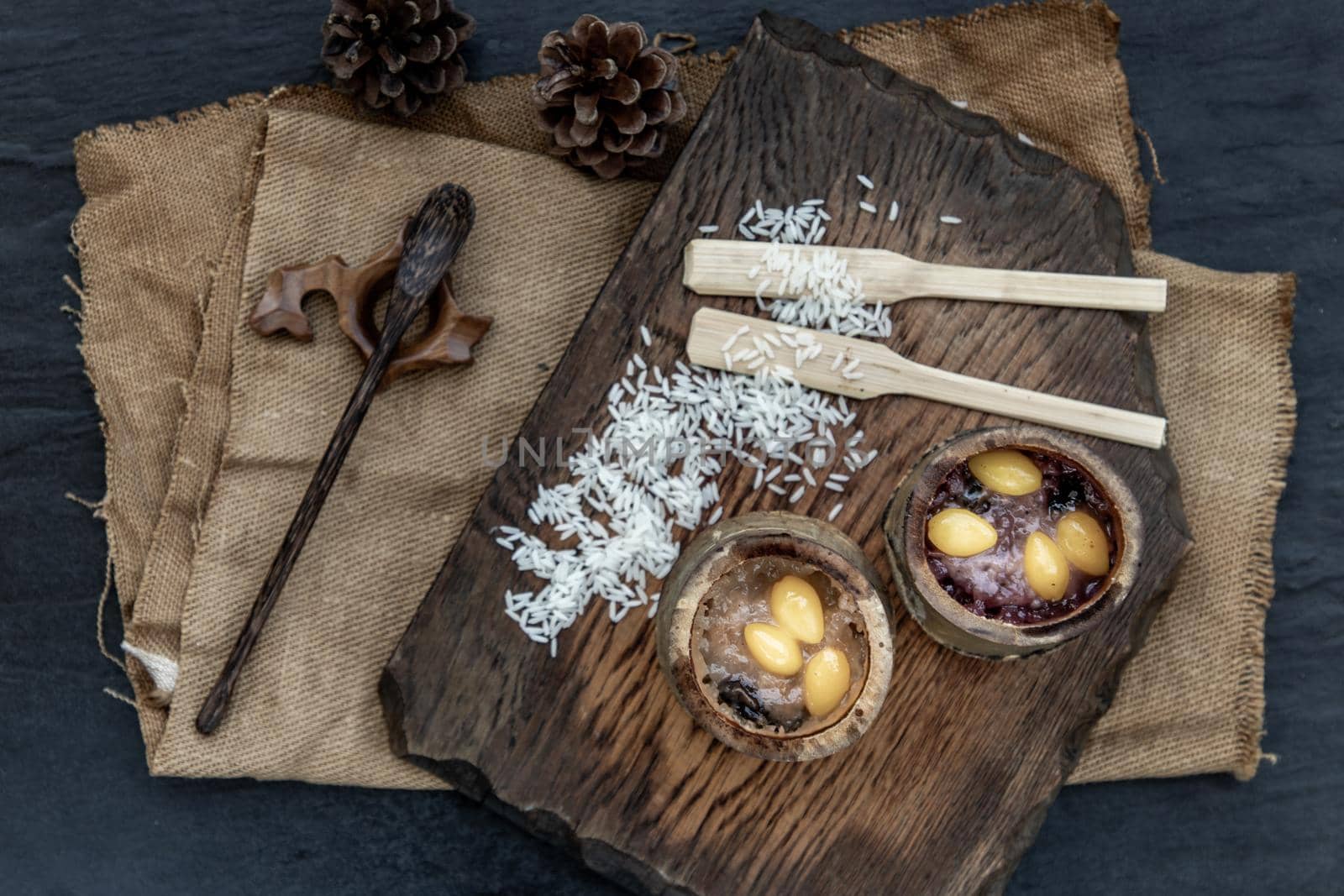 Sticky Rice Cooked with Coconut milk (Khao lam) or Glutinous rice roasted in bamboo joints on wooden, Thai dessert concept, Top view.