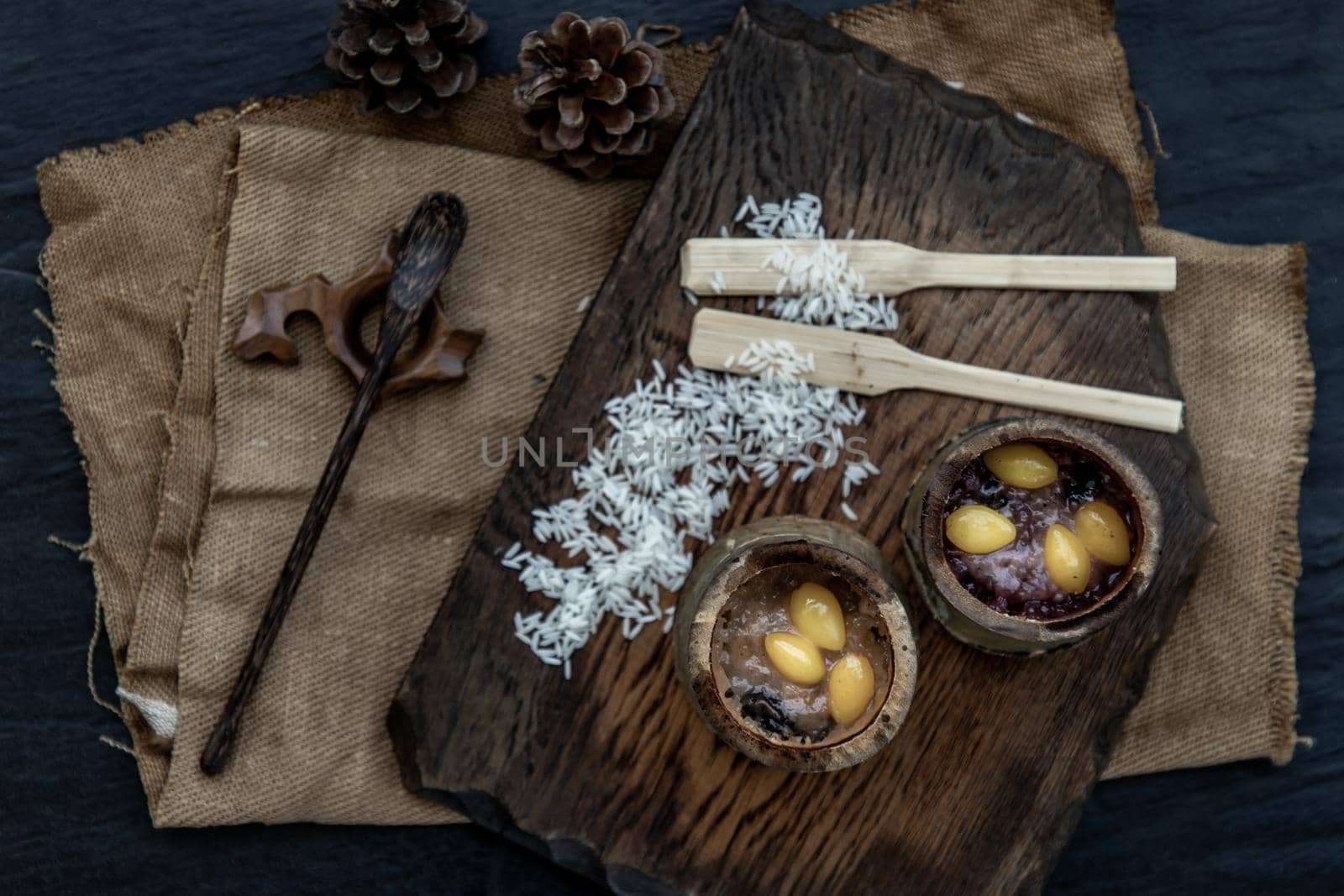 Sticky Rice Cooked with Coconut milk (Khao lam) or Glutinous rice roasted in bamboo joints on wooden, Thai dessert concept, Top view.