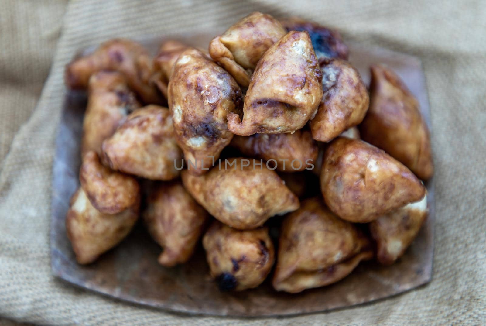 Close-up of Pansib pastry stuffed on burlap fabric background, Thai style dumplings stuffed, thai dessert, kind of snack, Selective focus.