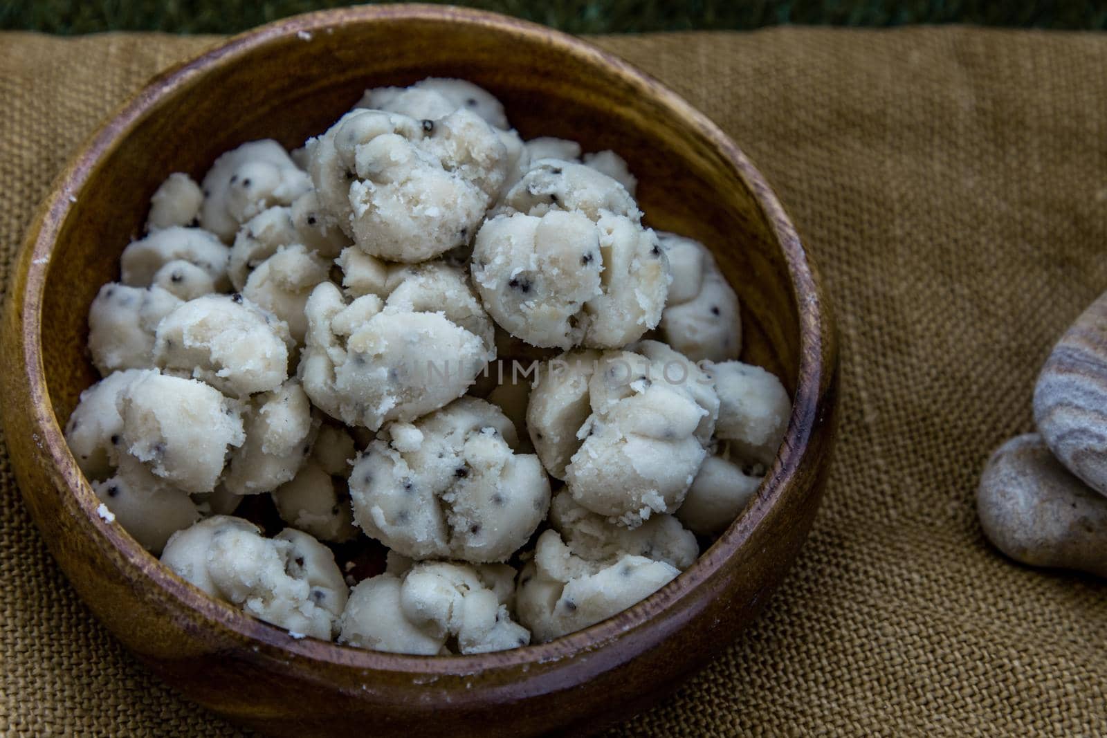 Thai Shortbread Cookies (Thai Dessert), Kanom Kleeb Lum Duen on burlap fabric background, Oblique view from the top, Selective focus.