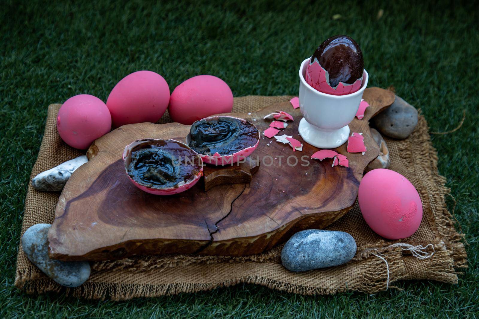 Asian Traditional Food, Pink Century eggs (Pidan Eggs) also known as preserved egg, hundred-year egg, thousand-year egg are a Chinese preserved food product and delicacy made by preserving duck, chicken in A Mixture of Ash, Salt, Red Lime, Sodium Carbonate, Tea Leaves and Zinc Oxide, Selective focus.