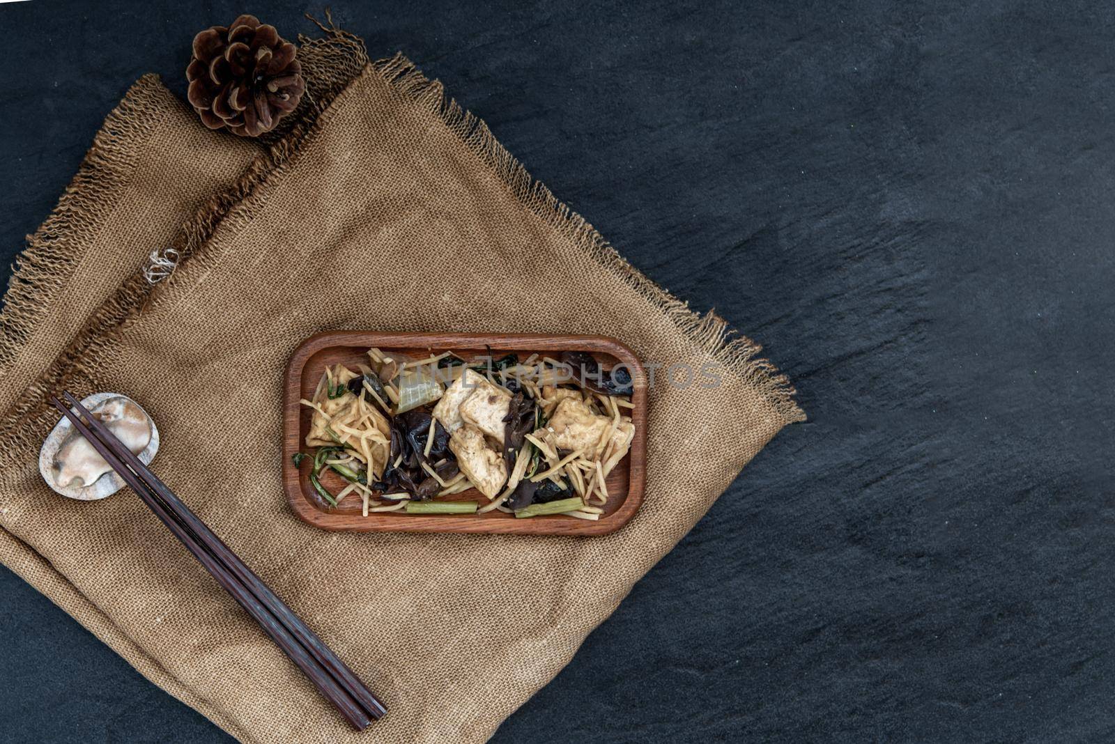 Thai food, Stir-fried tofu with ginger in wooden tray, view from above.