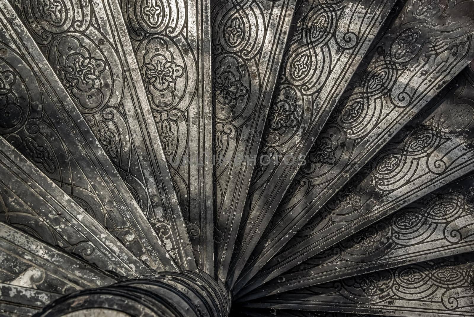 Bangkok, Thailand - Oct 05, 2019 : Upside view of a spiral staircase pattern. Spiral stairs circle in old cozy courtyard architecture. House ladder decoration interior. Architectural element of a historic building. Close-up