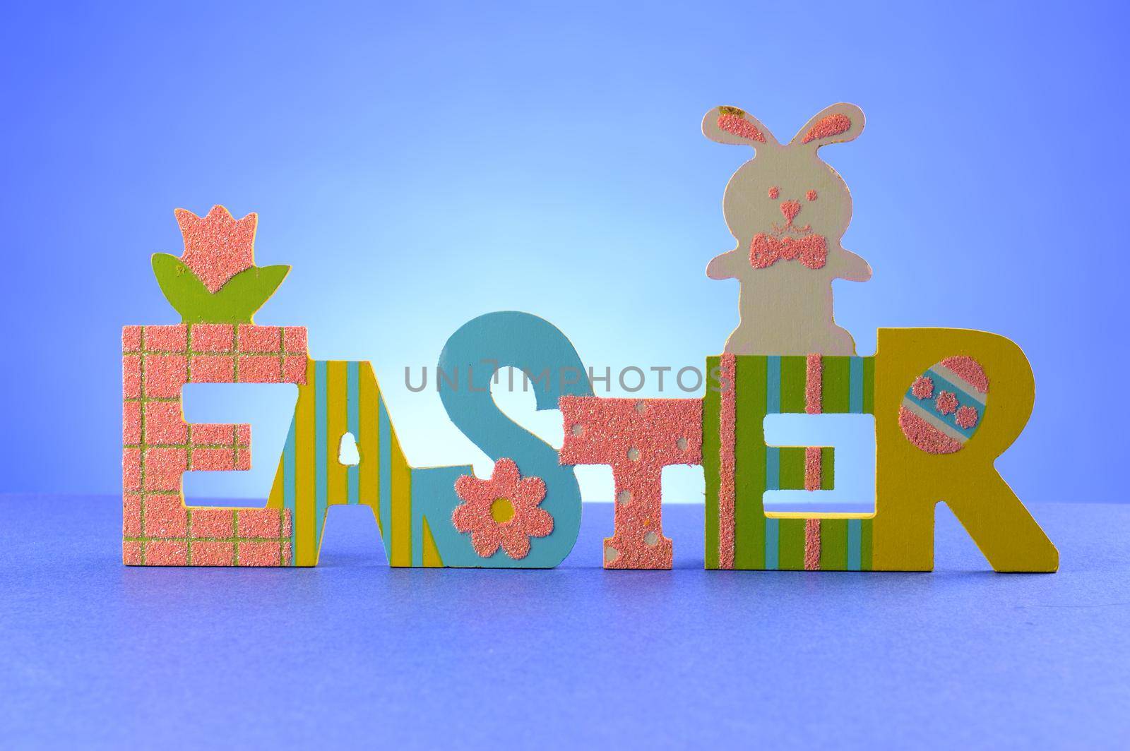 A festive Easter sign for the holiday season over a blue background.