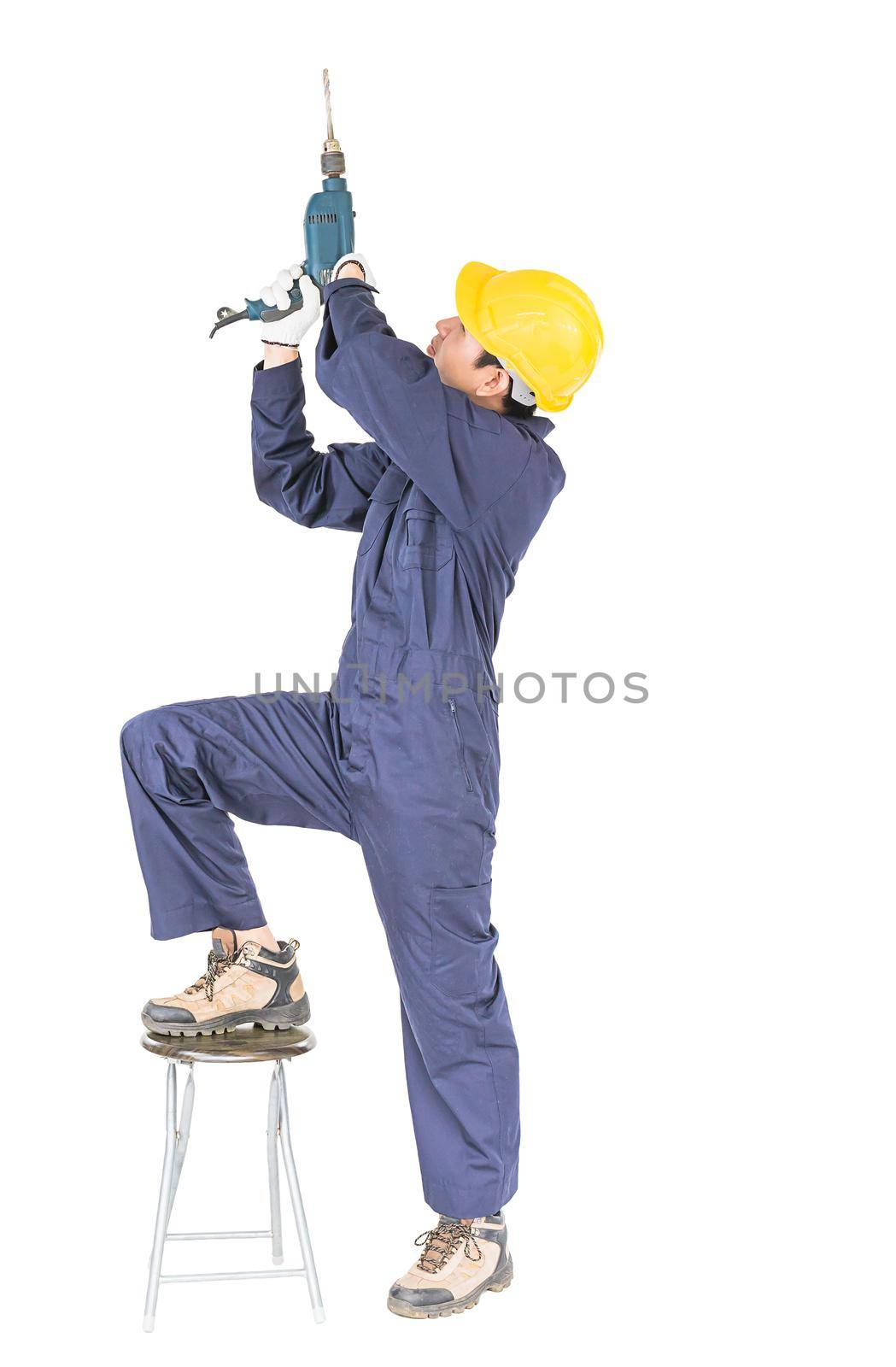 Young handyman in unifrom standing with his electric drill, Cutout isolated on white background with clipping path