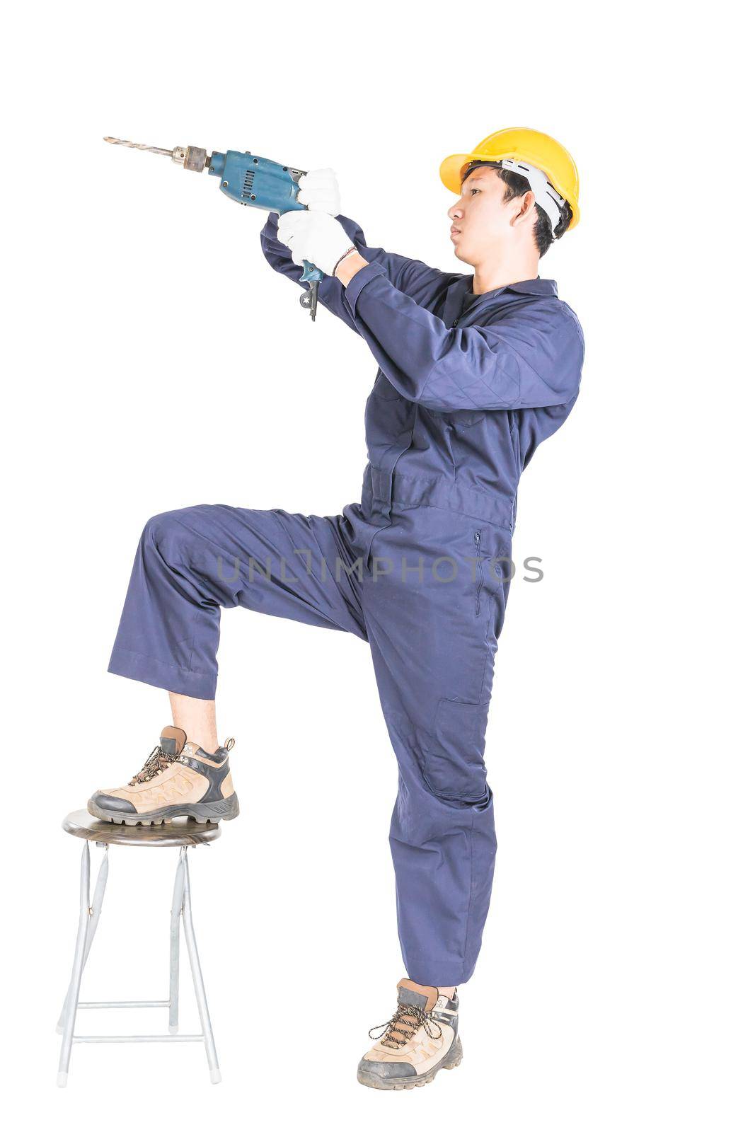Young handyman in unifrom standing with his electric drill, Cutout isolated on white background with clipping path