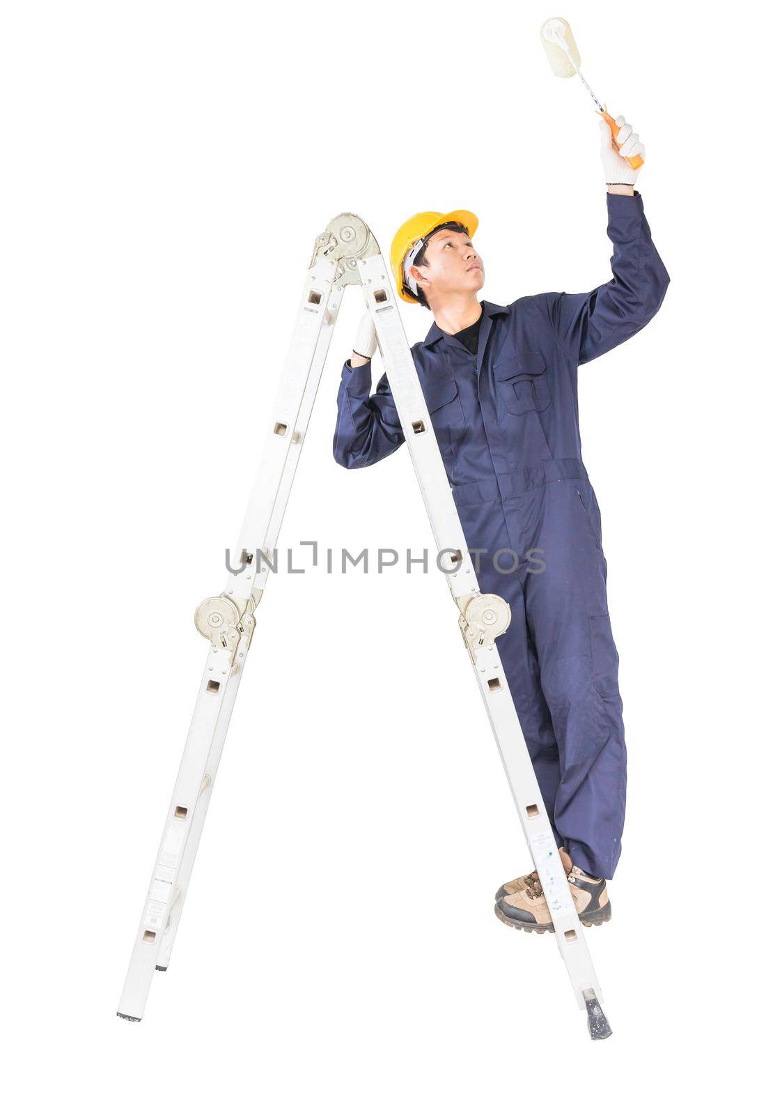 Handyman in uniform standing on ladder while using paint roller with clipping path by stoonn