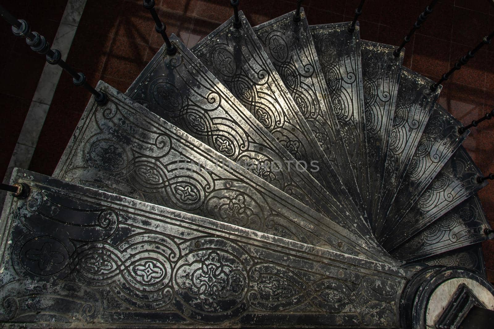 Bangkok, Thailand - Oct 05, 2019 : Upside view of a spiral staircase pattern. Spiral stairs circle in old cozy courtyard architecture. House ladder decoration interior. Architectural element of a historic building. Close-up