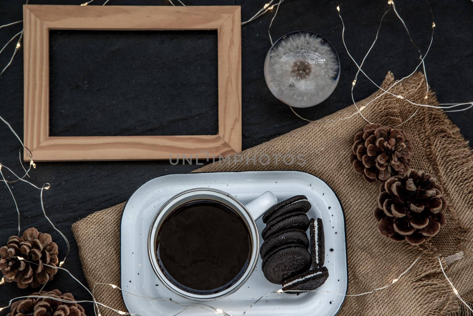 Cup of coffee with chocolate chip cookies on wooden tray. Concept for a tasty snack, Selective focus, Top view.