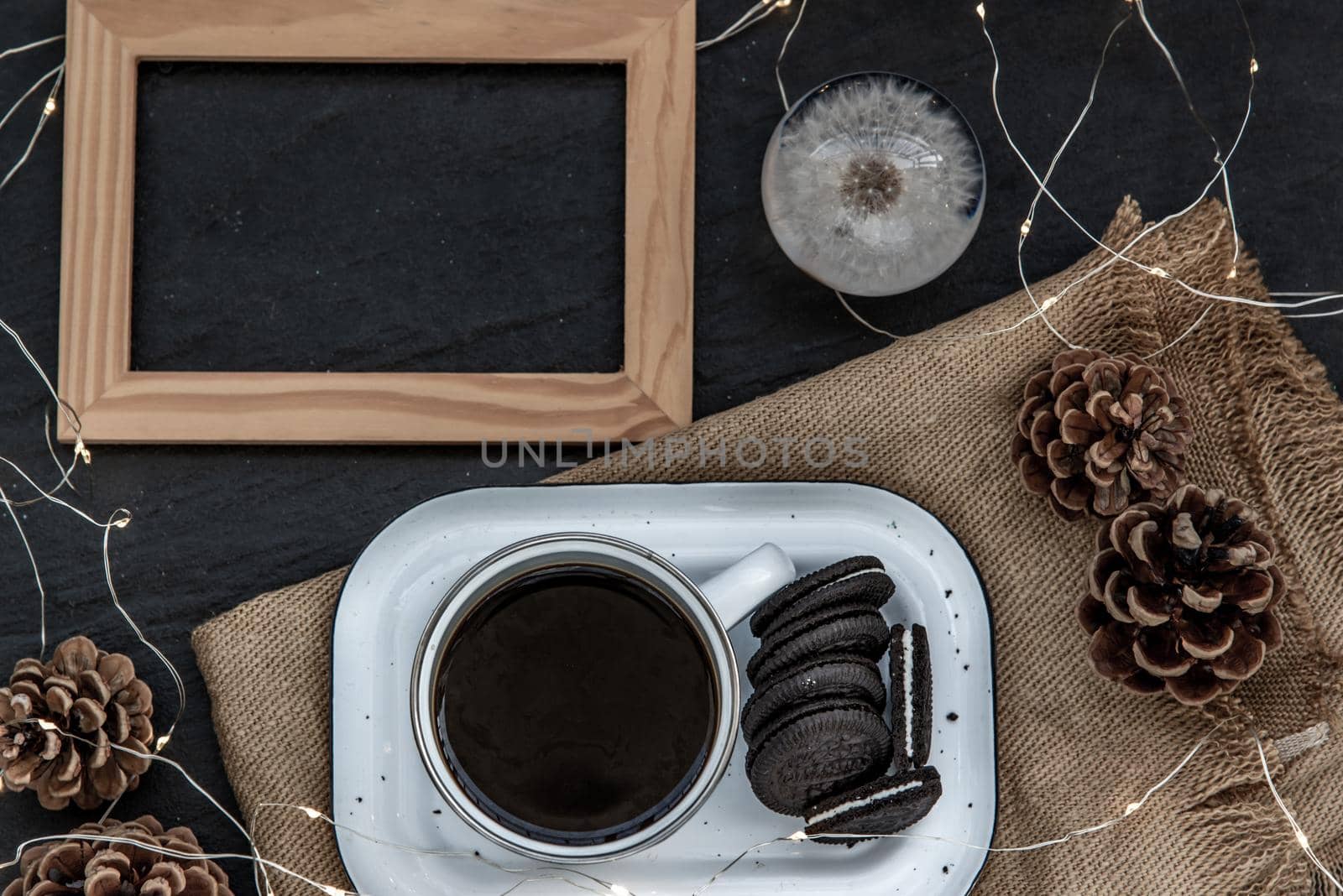 Cup of coffee with chocolate chip cookies on wooden tray. Concept for a tasty snack, Selective focus, Top view.