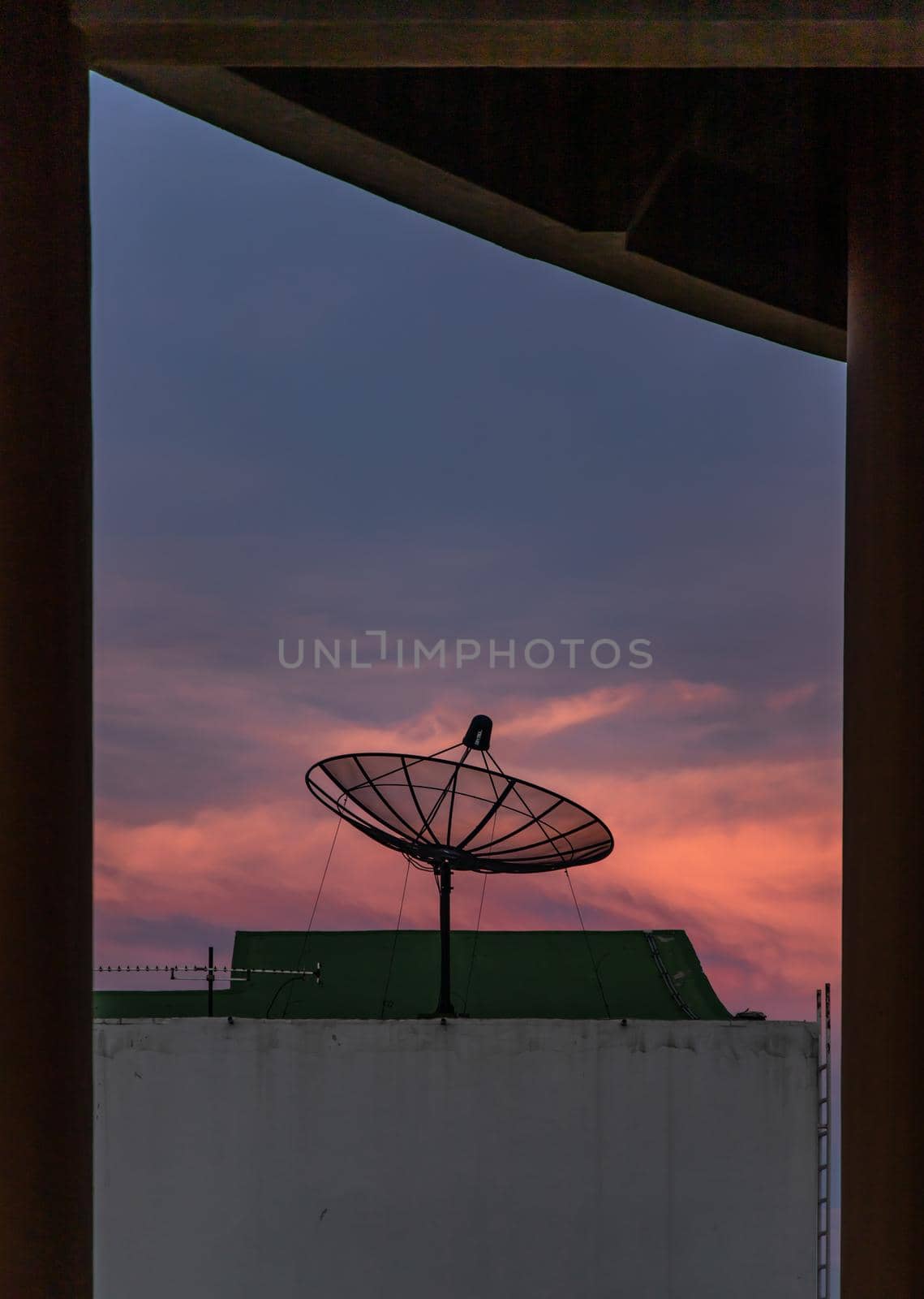 Black Satellite Dish Antenna Receiver Against on Blue Sky background  for Communication and Media Industry, Symbolizing Global Communications. Selective focus.