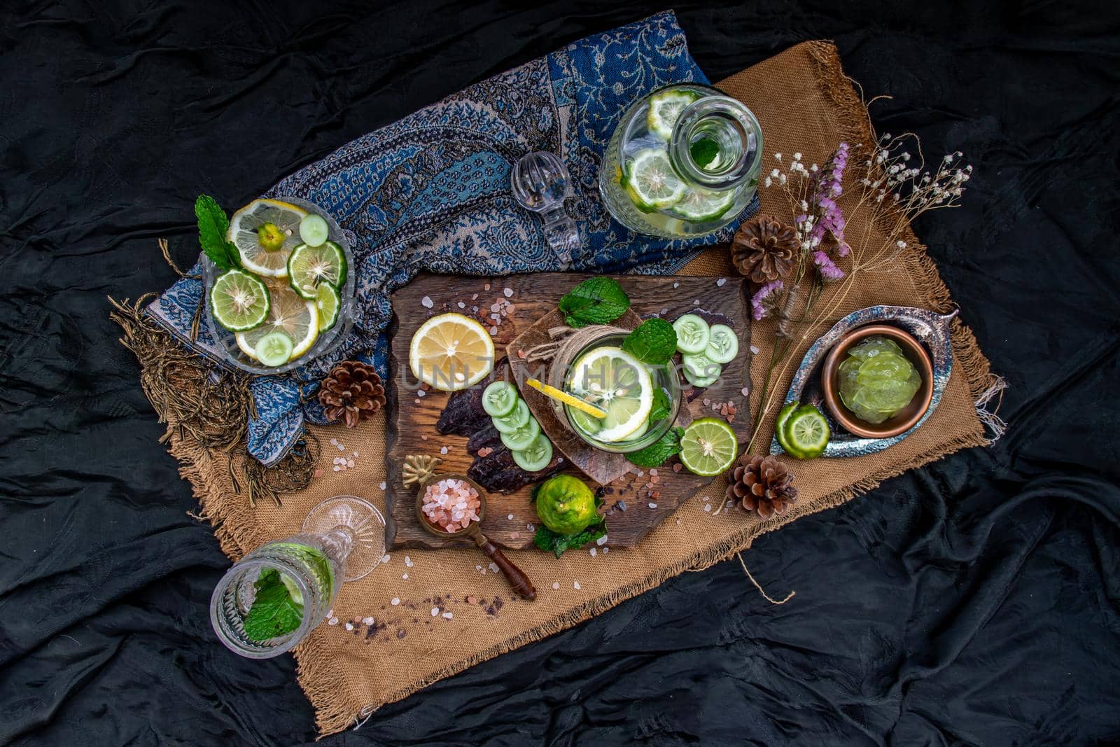 Cold water with lemon, kaffir lime, cucumber and mint leave on wooden background. Summer time, Healthy drink, vegetable juice, healthy food concept, Selective Focus.