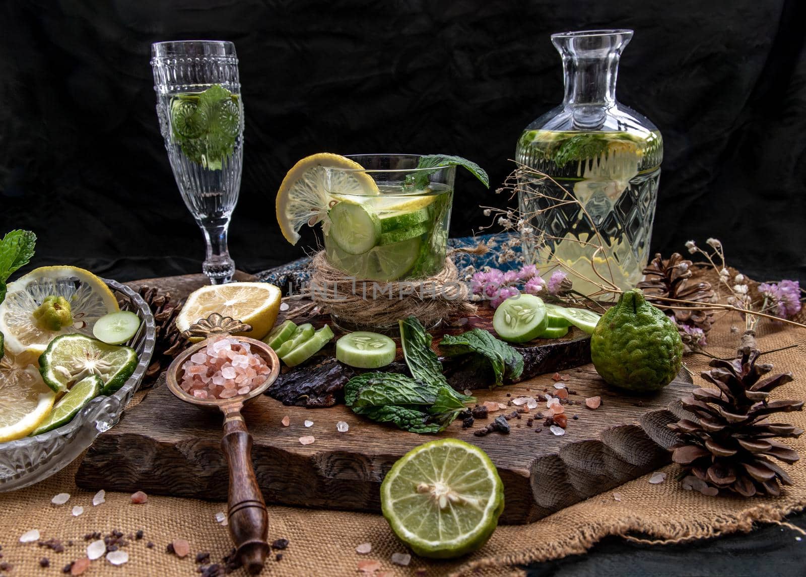 Cold water with lemon, kaffir lime, cucumber and mint leave on wooden background. Summer time, Healthy drink, vegetable juice, healthy food concept, Selective Focus.