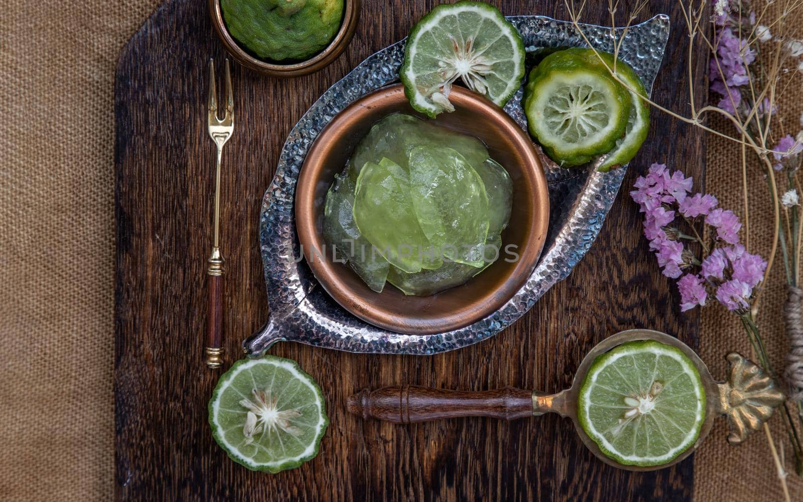 Traditional Thai dessert call candied kaffir lime on wooden background. Summer time, Selective Focus.